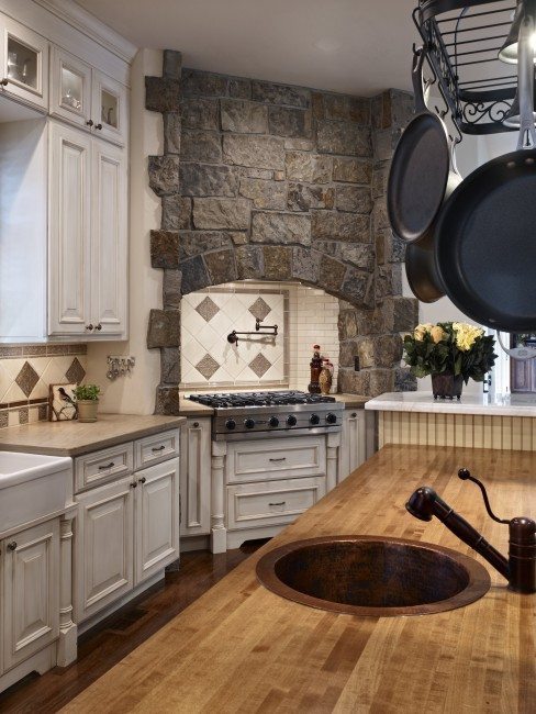 kitchen with stone hearth and butcher block counters